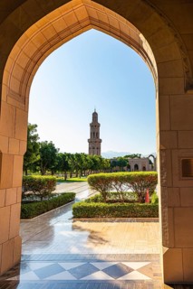 Arched gate and minaret of the Sultan Qaboos Mosque, Muscat, Arabian Peninsula, Sultanate of Oman