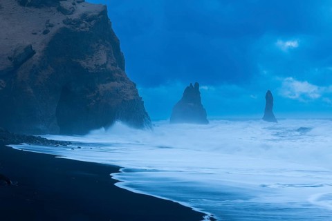 Reynisdrangar pinnacles, lava sandy beach, lava rocks, sea, waves, surf, blue hour, Vik, Iceland,