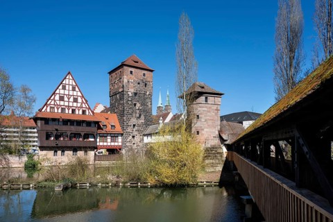 View of the Pegnitz river with the Weinstadel half-timbered building, the water tower and