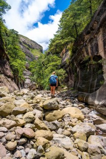 Female hiker in the Tugela Gorge or Tugela Gorge in the riverbed, Drakensberg National Park,