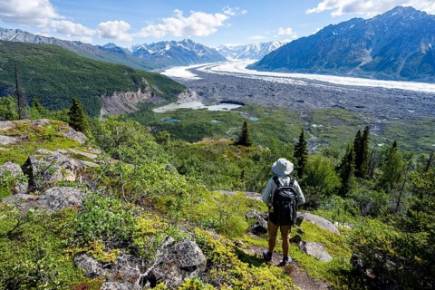 Young man enjoying the view, view of impressive mountain landscape with Matanuska glacier and