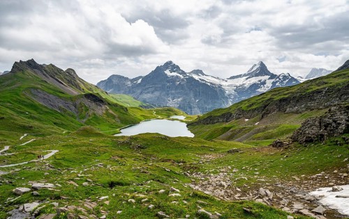Mountain landscape with Bachalpsee mountain lake, Mittelhorn peaks and Schreckhorn with upper