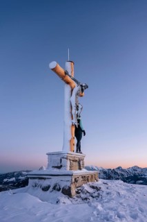 Summit bliss in the snow-covered winter landscape in the Tannheimer Tal in the Alps on the