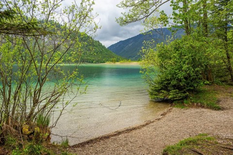 Landscape of Lake Offensee after rain when the sun comes through the clouds in spring,