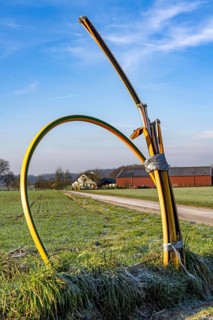 Fibre optic connection, empty conduits protrude from the ground along a dirt track, into which the