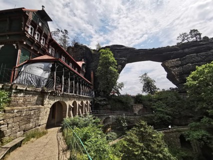 Historic building on an impressive rock formation with a natural stone bridge over it, Elbe