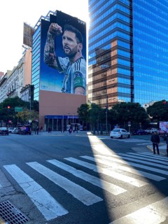Giant photograph of Lionel Messi in winning pose, advertising for YPF, Avenida 9 de Julio, centre