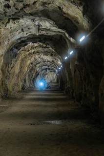 Stony tunnel with artificial lighting in an underground cave, Klein Tibet, Zillertal, Austria
