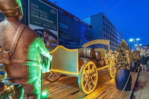 Light installation beer carriage with horses at Dortmund's Christmas market at dusk, Dortmund,