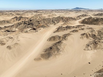 Aerial view, dry barren mountains in Moon Valley, rocky landscape ridged by erosion, Namib-Naukluft