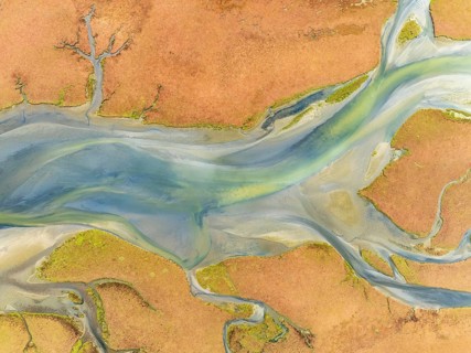 Streams at low tide in the marshland of the Walvis Bay lagoon. Aerial view. Drone shot. Walvis Bay,