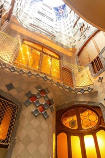 Sunlight streams through the colorful stained glass and intricate tilework of the interior