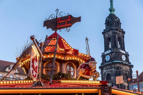 Detailed decoration on the stalls of the Christmas market, with the Kreuzkirche tower in the