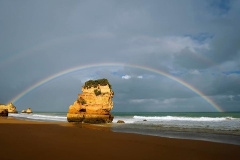 Rocks on beach with rainbow, Praia Dona Ana, Lagos, Algarve, Portugal