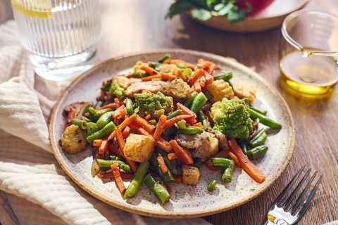 Plate of stir-fried mixed vegetables with green beans, carrots, baby corn, romanesco and mushrooms