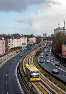 Essen, North Rhine-Westphalia, Germany - Cars and a public bus drive through Essen city centre on