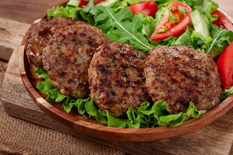 Fried cutlets, mixed minced meat, with vegetable salad, homemade, top view, no people