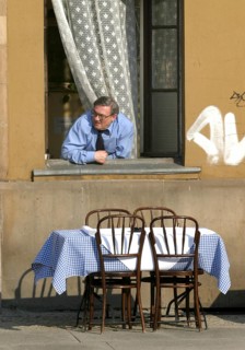Wroclaw, POL, 30.04.2004 - A man looks out of the window of an inn in Wroclaw, Poland