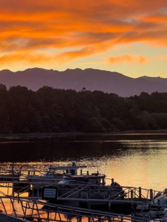 Sunrise with boats in the water on the Waiau River, Manapouri, South Island, New Zealand, Oceania