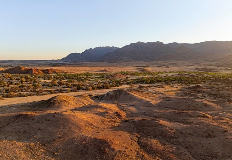 Aerial view, dry riverbed and desert landscape on the Ugab River, behind Brandberg, Erongo,