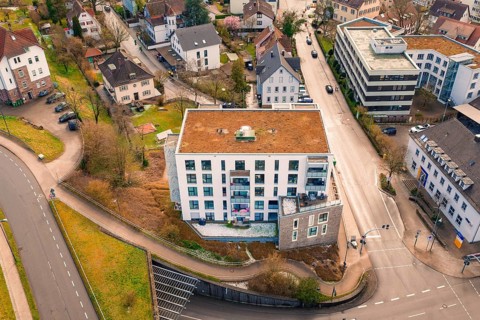 Modern residential building at an urban road junction, from a bird's eye view, Nagold, Calw