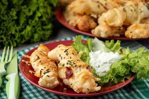 Ready baked cheese rolls with dip and salad served on a plate