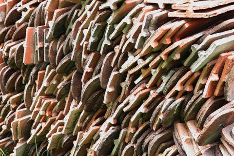 Old roof tiles stored on stockpiles for reuse on historic buildings and heritage-protected houses,