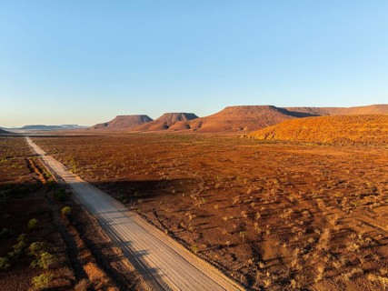 Aerial view, road leading through dry desert landscape, hills in Damaraland, Namibia