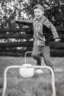 7 year old boy plays football in the garden in Lubin, Poland