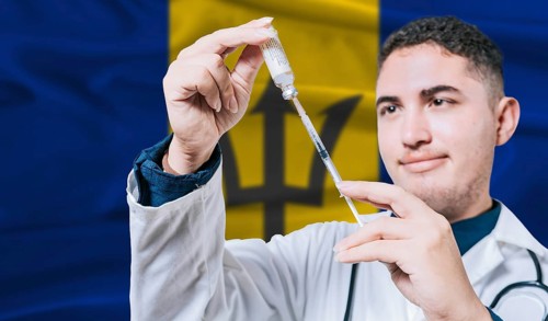 Doctor holding syringe on Barbados flag background. Medical professional holding syringe with