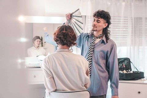 Professional makeup artist assisting a client in selecting the ideal foundation shade from a color