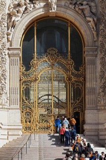 Queue of visitors in front of the golden entrance to the Petit Palais, Beaux Arts style building,