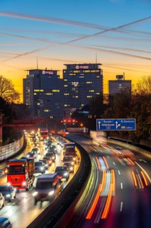Evening traffic, partly with traffic jams, slow-moving traffic on the A40 motorway, Essen skyline,
