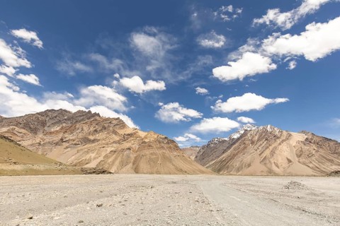 Majestic mountains rise under a clear blue sky, captured in the stunning Zanskar Valley of Ladakh,