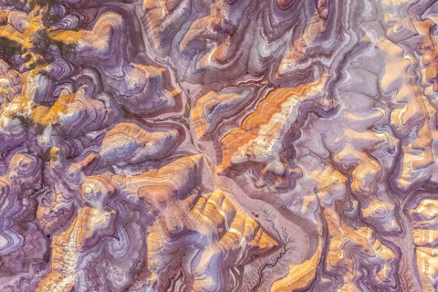 Aerial view of stunning, colorful bentonite formations in Utah, showcasing vibrant patterns and