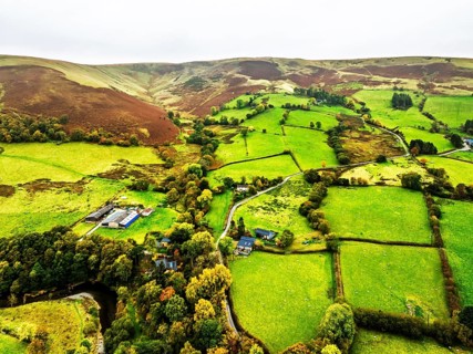 Autumn colours of Farms over River Wye and Road A470 from a drone, Llanidloes, Powys,
