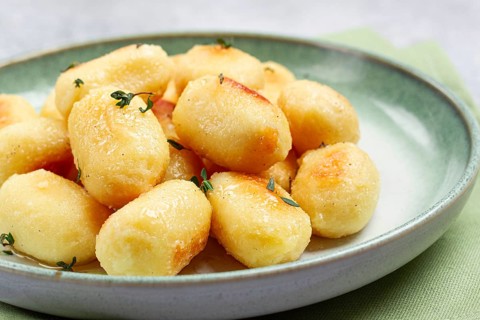Stuffed gnocchi with cheese, Italian dumplings, garnished with parmesan cheese, no people