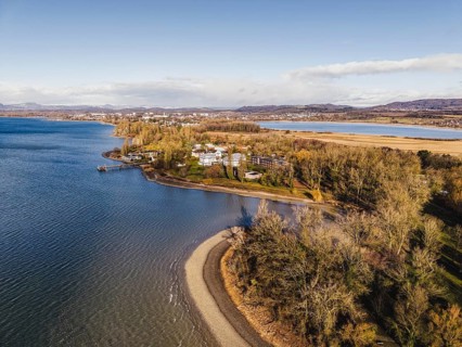 Aerial view of the Mettnau peninsula in western Lake Constance with winter vegetation with the spa
