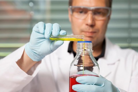 A young laboratory technician experimenting with chemicals, chemist, laboratory, Federal Republic