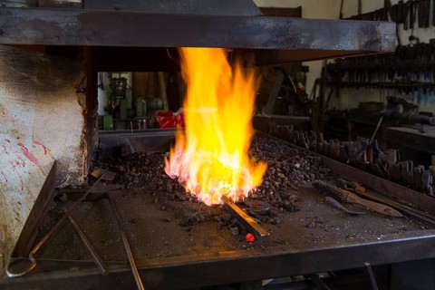 A blacksmith forging, working at the Ehnert forge in Dresden-Bühlau, Saxony, Germany