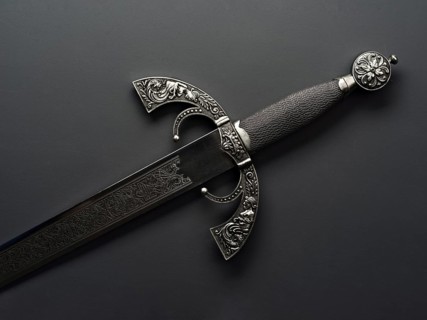 This image showcases a beautifully crafted Spanish steel sword, featuring intricate engravings and