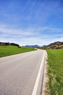 Mountain landscape, meadows, mountains, hills, coniferous forest, homesteads, road, curve, image