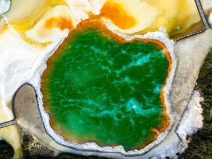 A breathtaking aerial view of Champagne Pool in Wai-O-Tapu geothermal park, New Zealand, showcasing