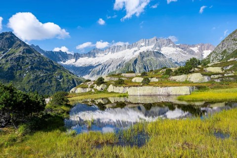 Picturesque mountain landscape, dammastock and damma glaciers reflected in Moorsee, Göscheneralp,