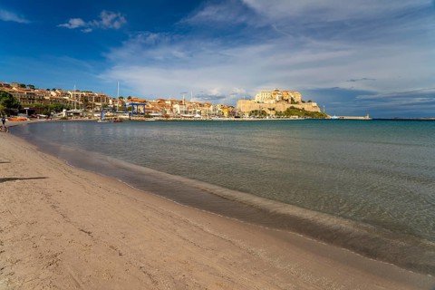 The beach and city view with marina and citadel in Calvi, Balagne, Corsica, France