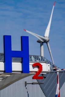 Hydrogen filling station in Antwerp, for cars and lorries, H2 lettering, wind turbine in the
