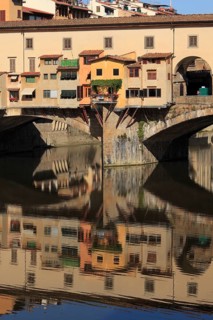 Ponte Vecchio and reflection in the river Arno, Florence, Tuscany, Italy