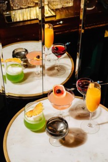 A luxurious selection of mixed cocktails with vibrant colors and unique garnishes, displayed on a