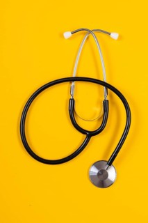 Stethoscope lying in front of a monochrome background