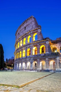 Colosseum ancient amphitheatre at night in Rome, Italy